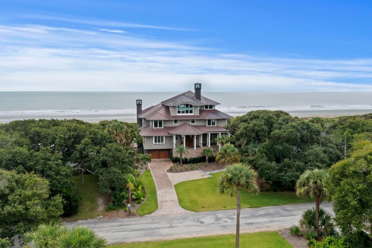 Aerial view of the house with the ocean in the background.