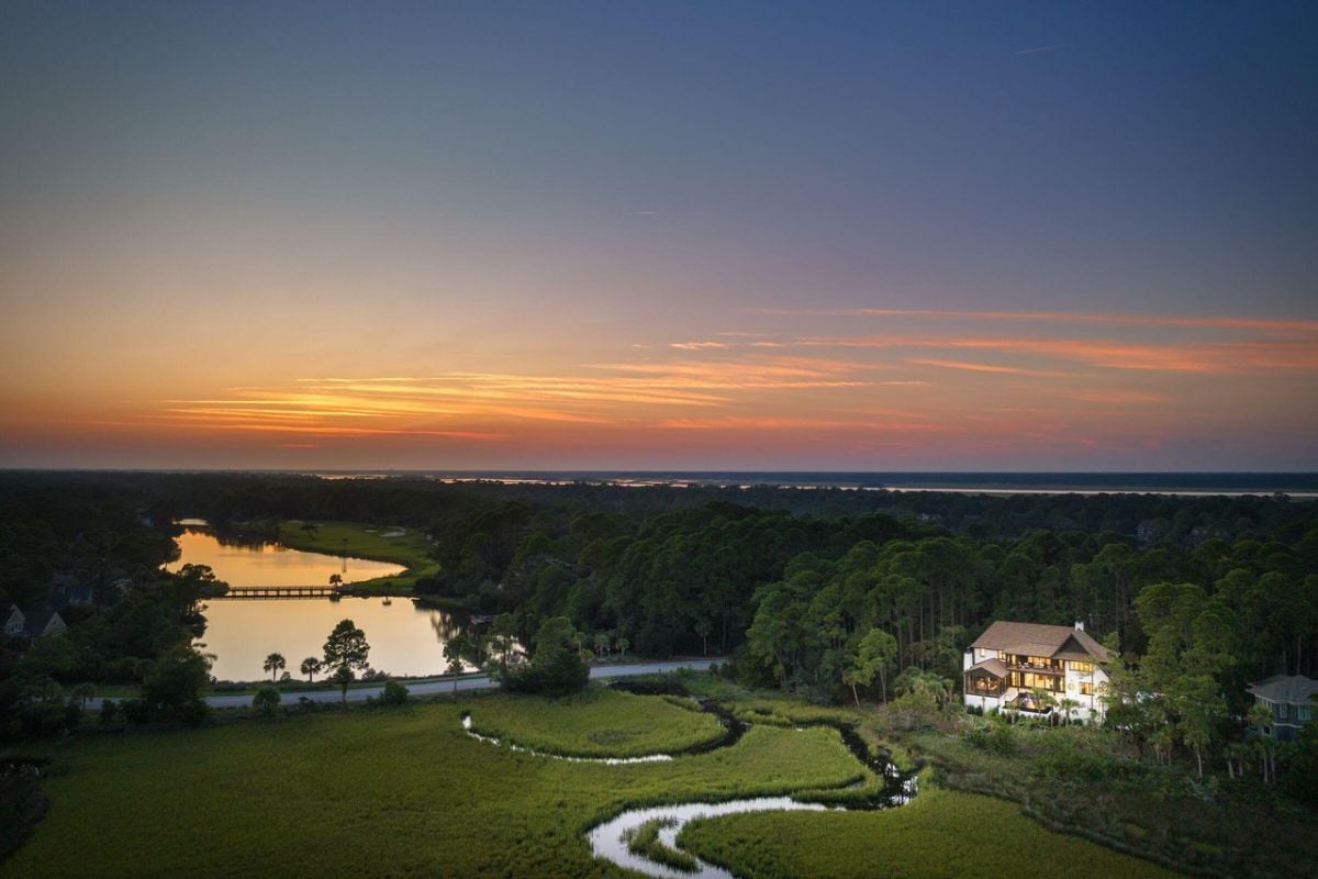 Aerial view of the property with trees in the background.