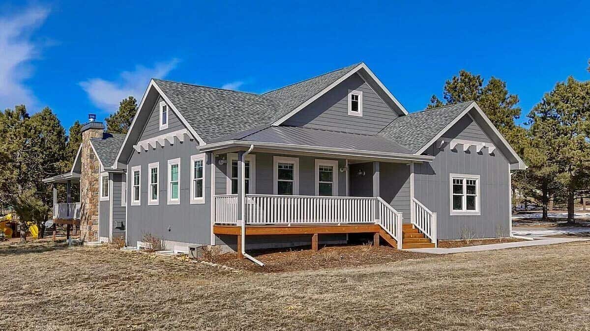 Front-left view with multiple gables and a covered entry porch.