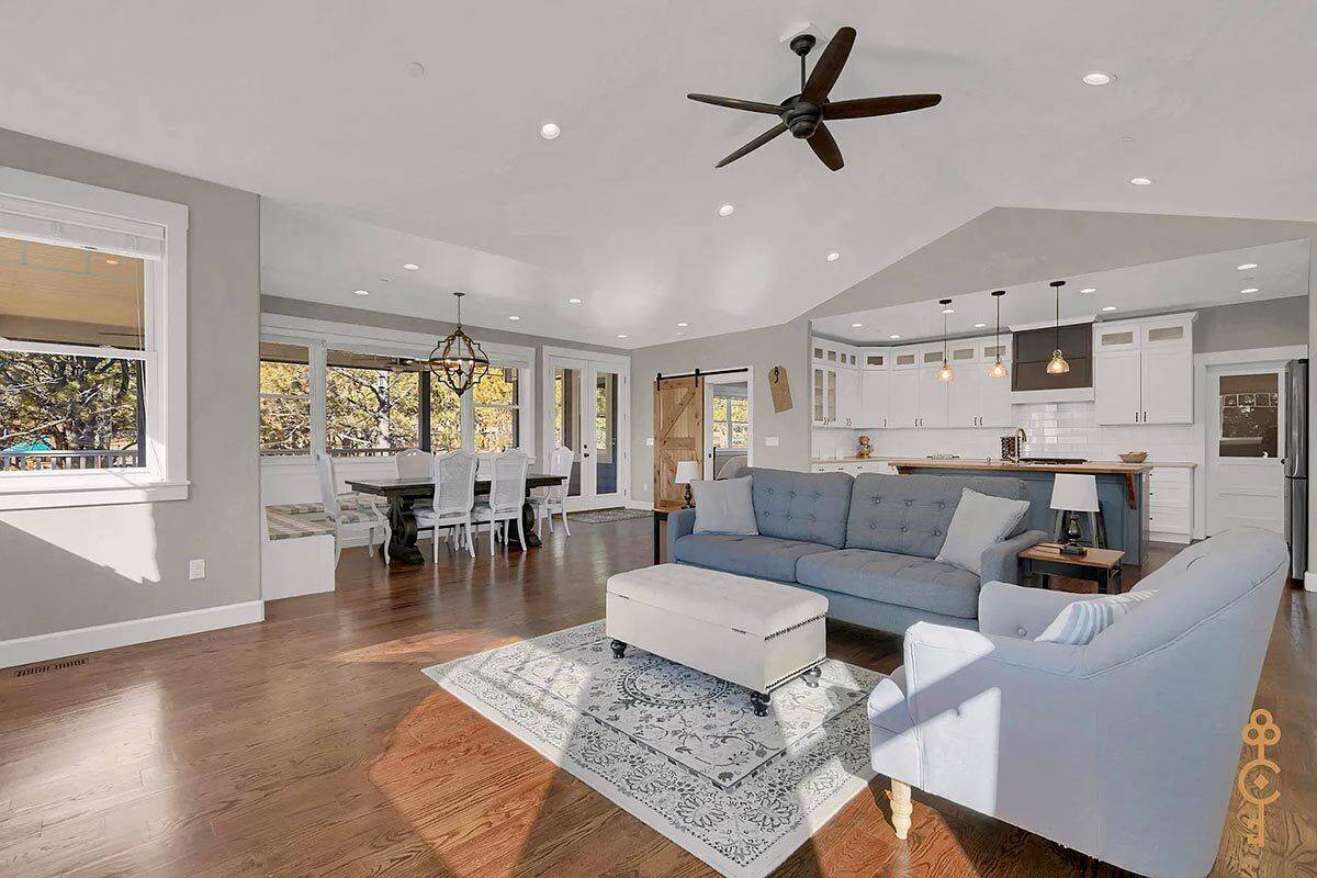 An open layout view of the great room, dining area, and kitchen under the vaulted ceiling.
