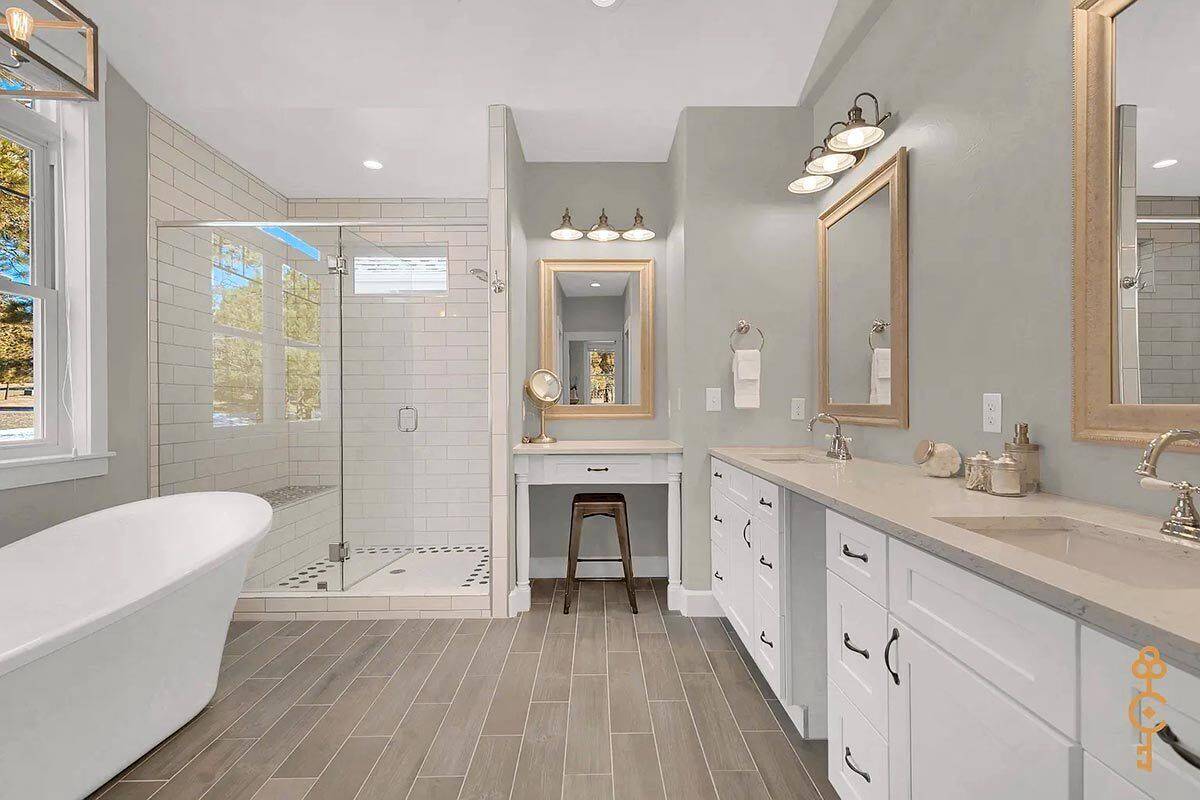 Primary bathroom with a dual sink vanity, a freestanding tub, and a walk-in shower.