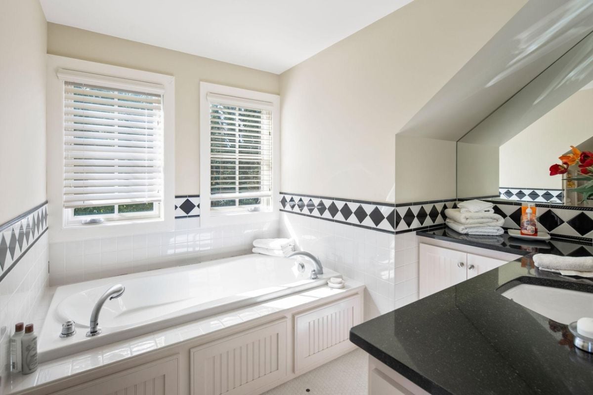 Bathroom with a sink and a soaking tub.