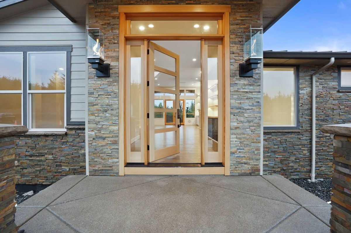 Entry door with a porch and glass door.