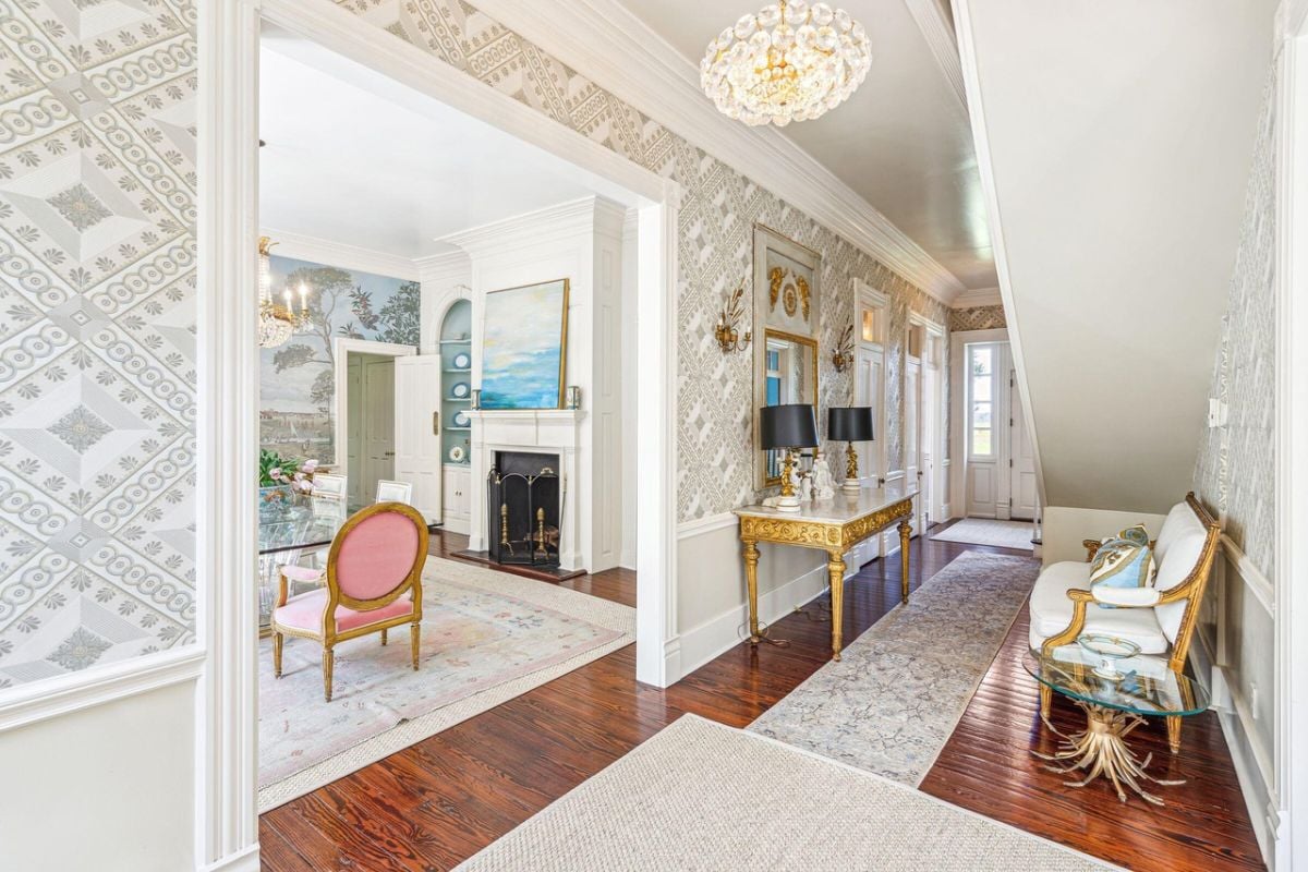 Foyer with a chandelier and a chair.