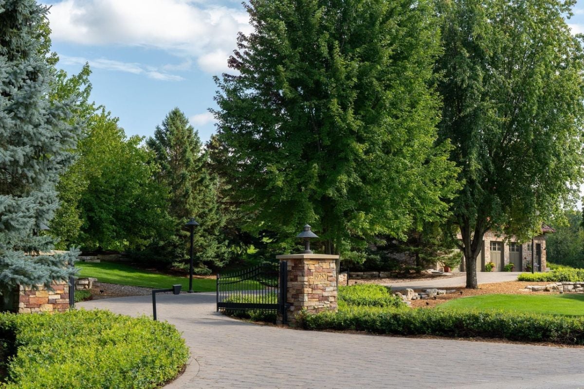 Main gate of the property with spacious driveway.