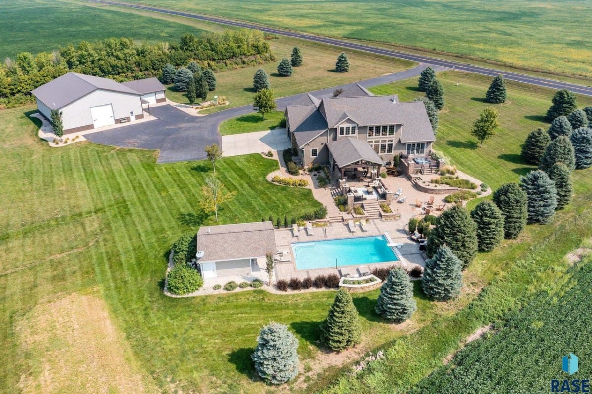 Aerial view of the house with a large green lawn.