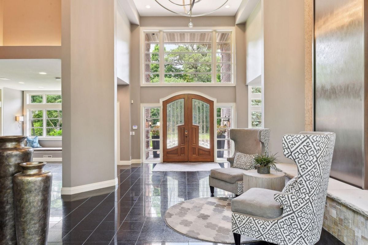 Foyer with chairs and a large door.
