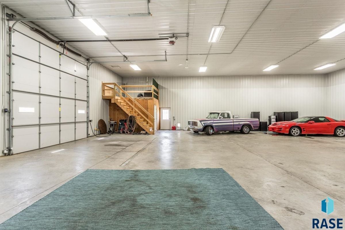 Garage with vehicles parked in it.