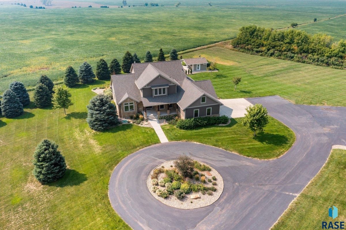 Aerial view of the house with spacious driveway and a large green lawn.