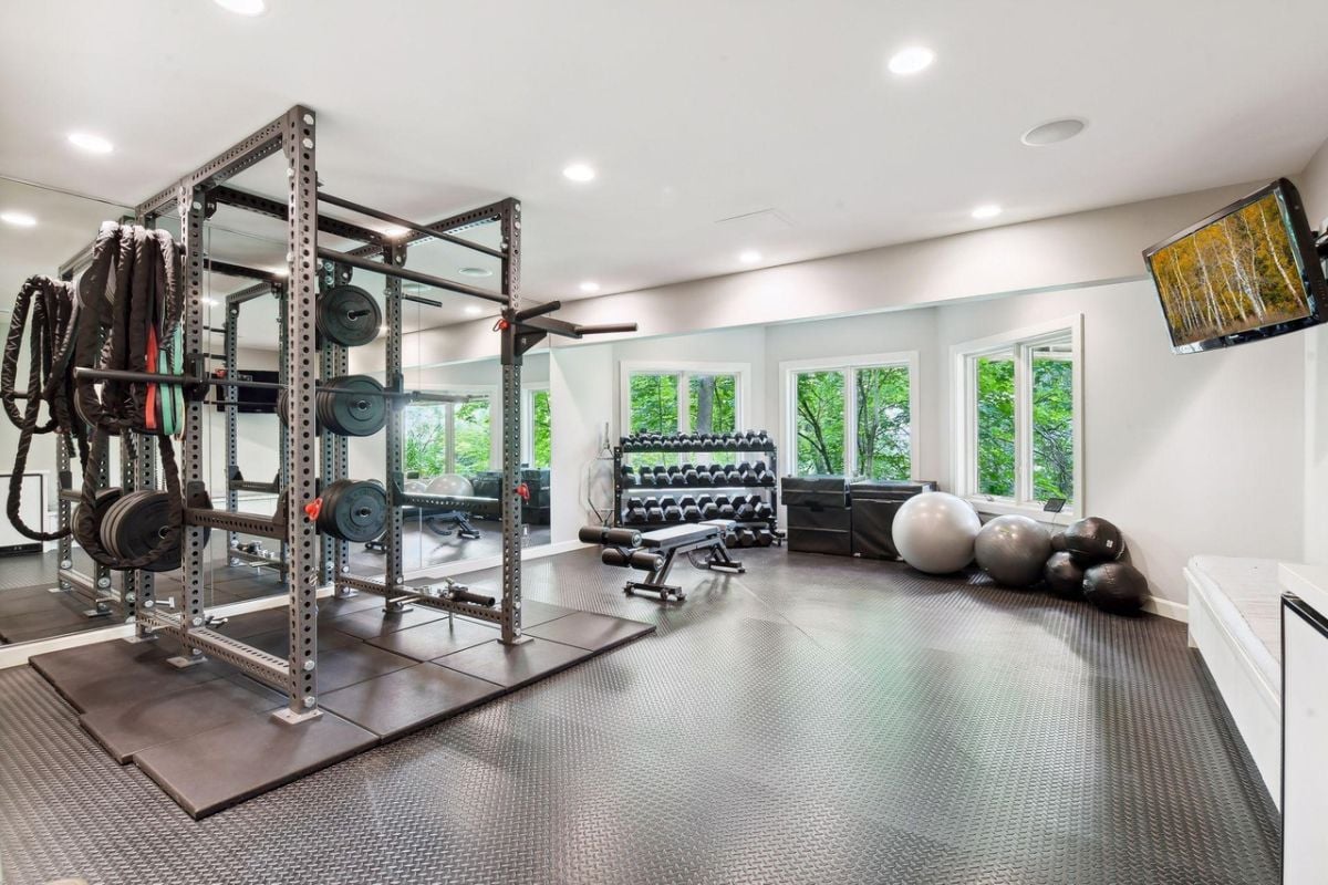 Home gym with lots of workout equipment.