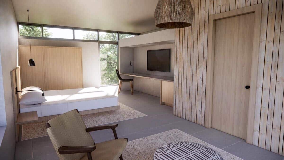 Primary bedroom with a bespoke bed, a built-in desk, and a sitting area.