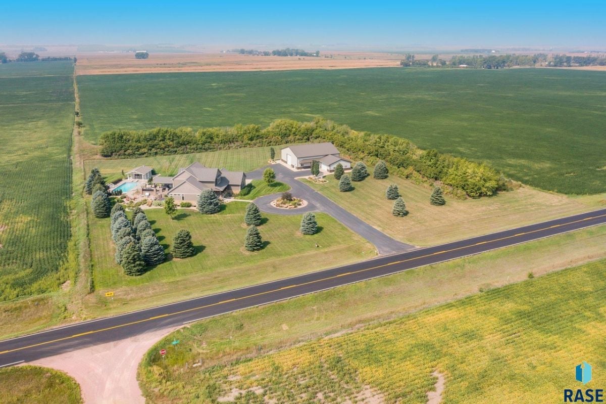 Aerial view of the property with a large green lawn.