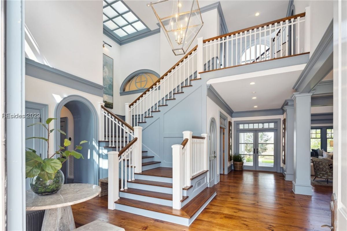 Foyer with wooden floors and a staircase.