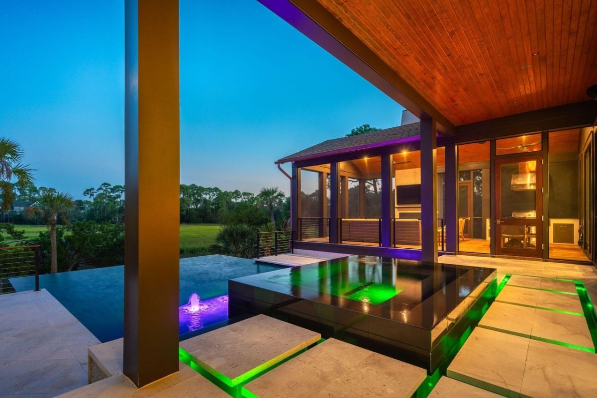 Modern home with a pool and a large patio.