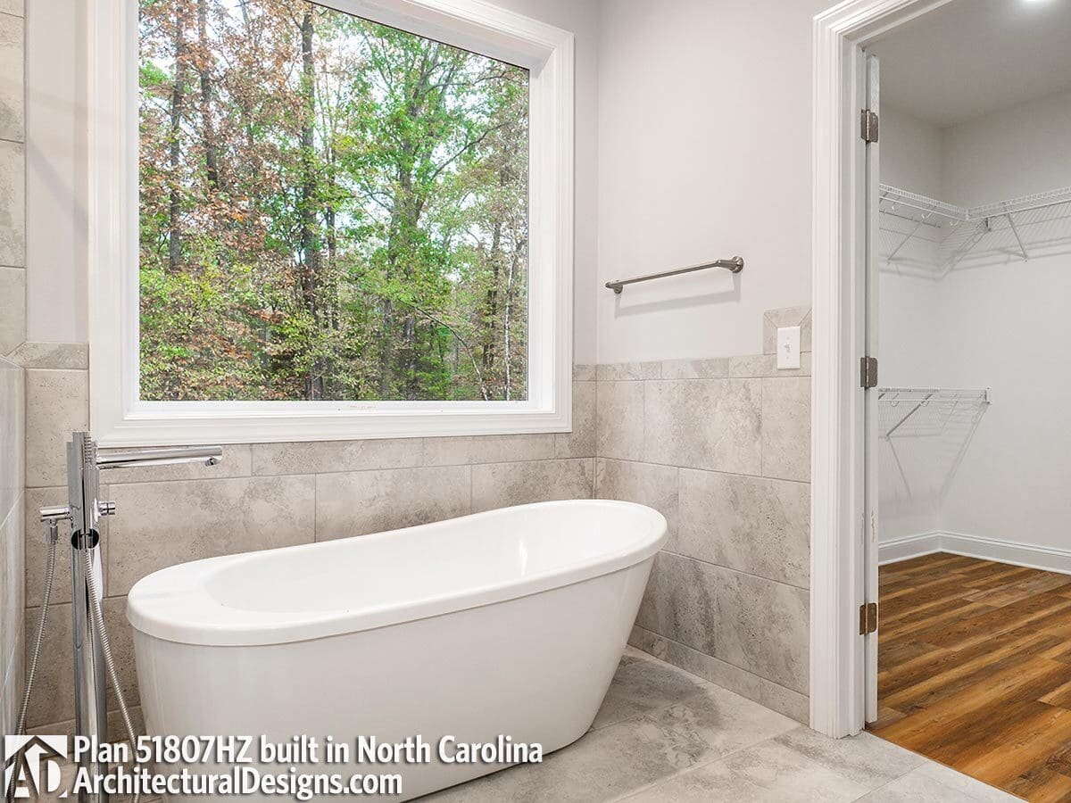 The primary bathroom includes a freestanding bathtub and a walk-in shower.