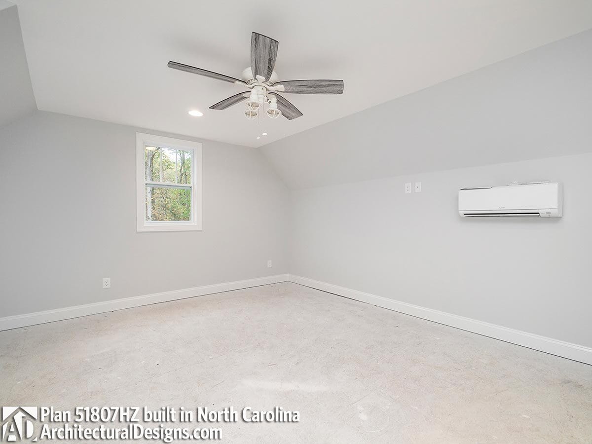 Bonus room with carpet flooring and a coved ceiling mounted with a traditional fan.