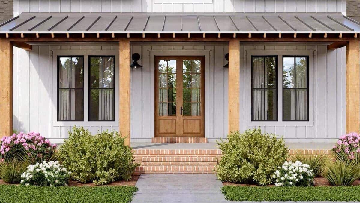 Front porch with a French door, wooden columns, and a brick stoop.