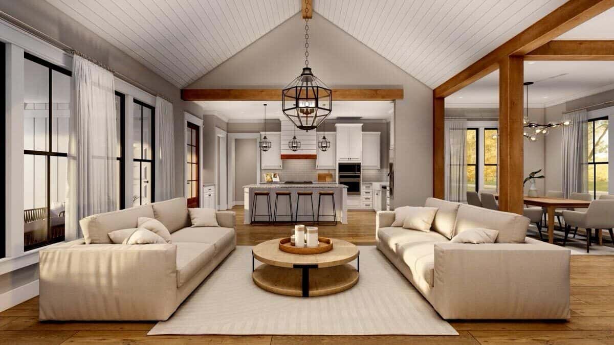Great room with facing sectionals and a round coffee table under a cathedral ceiling.
