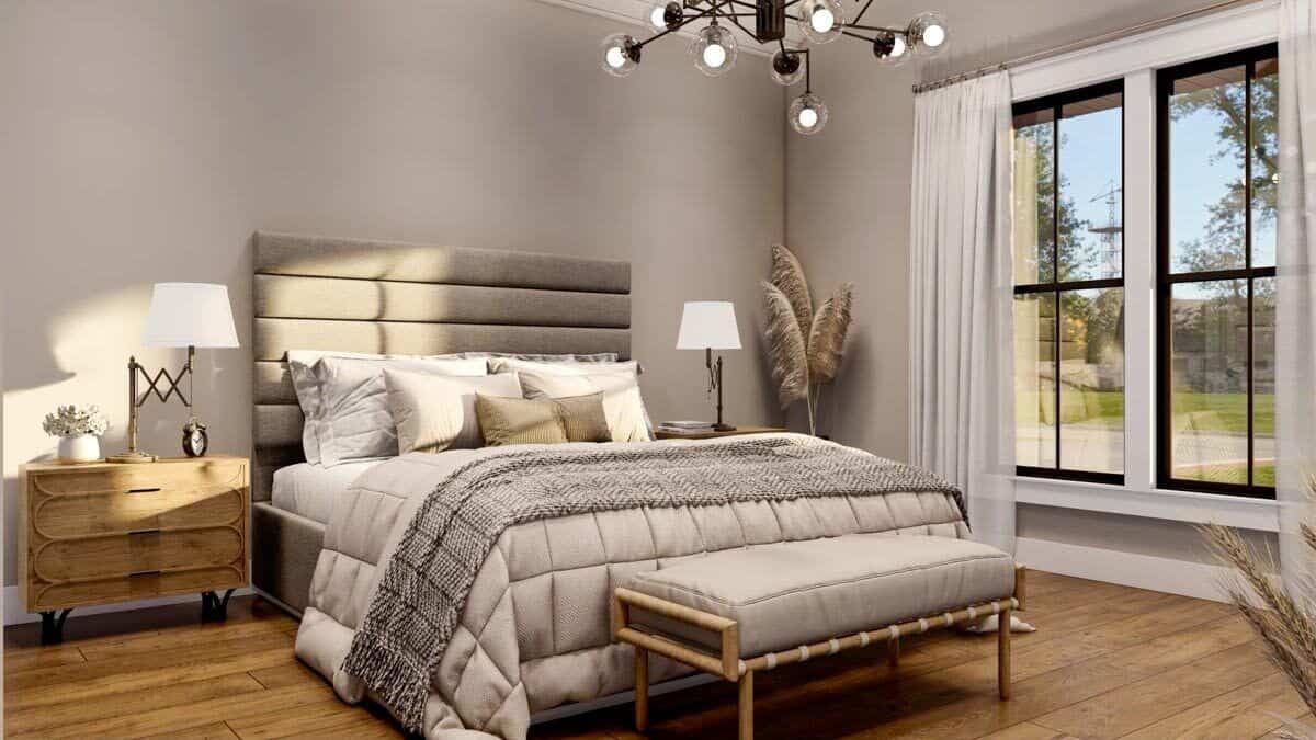 Primary bedroom with wooden nightstands and an upholstered bed complemented with a cushioned bench.