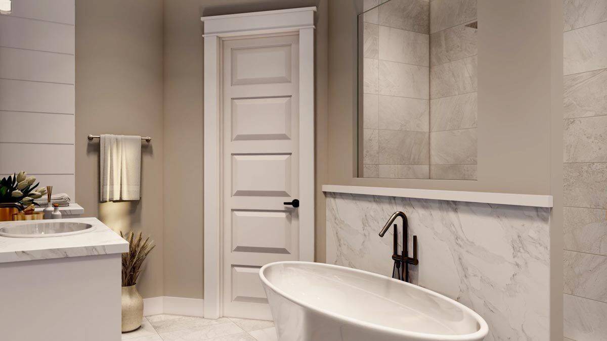 Primary bathroom with a marble-top vanity, a soaking tub, and a walk-in shower.