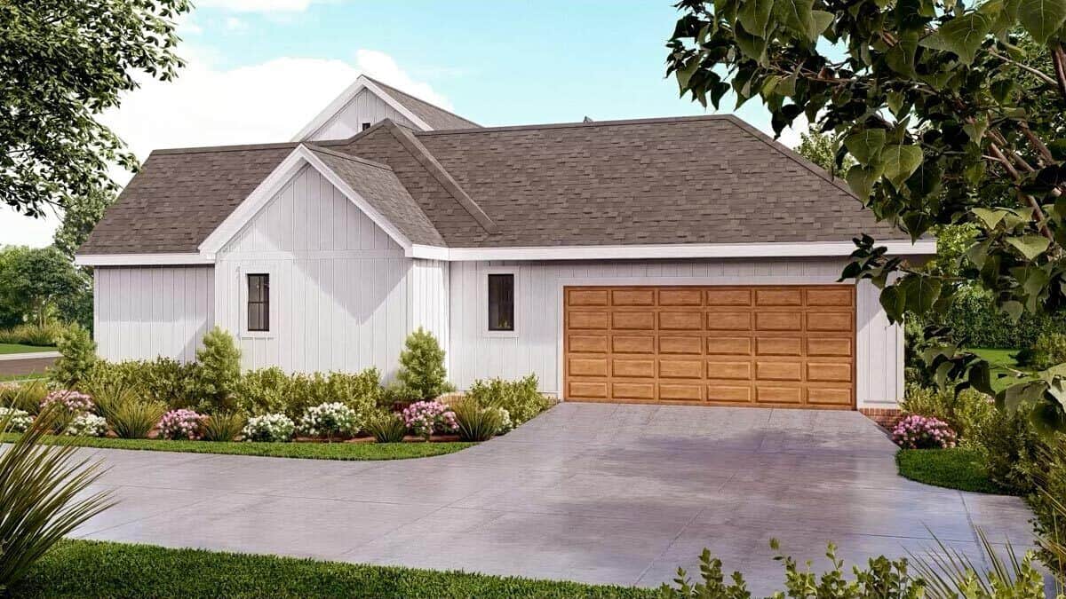 Right view of the house with a double garage and a concrete driveway.