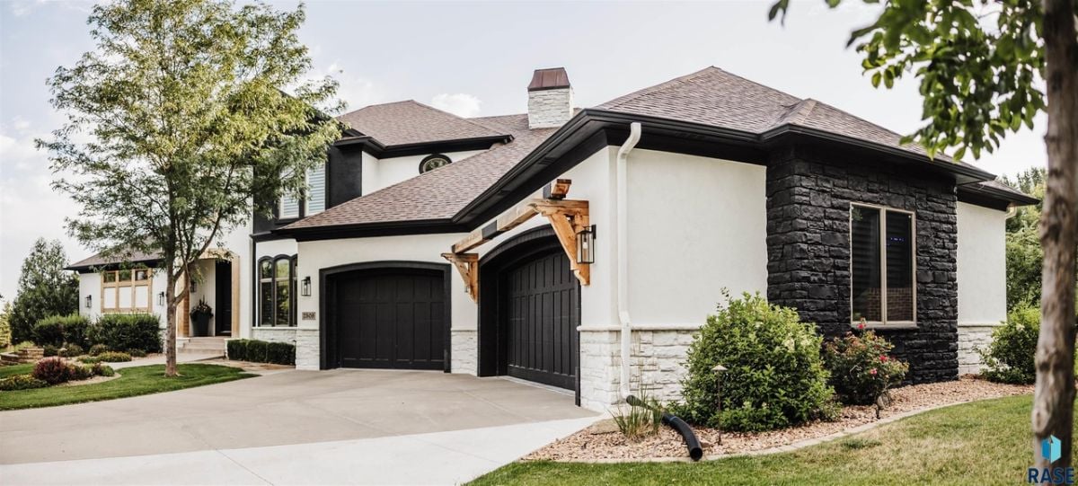 Front view of the house with a garage and spacious driveway.