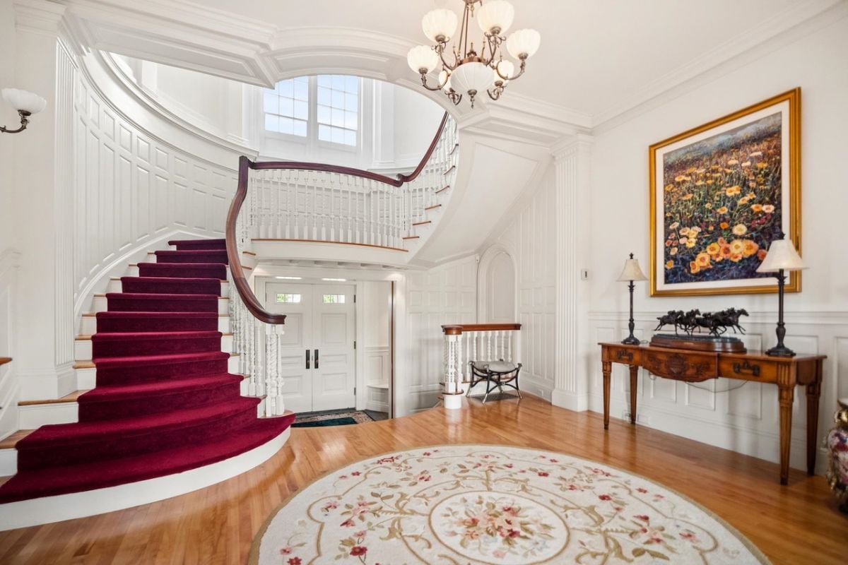 Foyer with a chandelier and a staircase.
