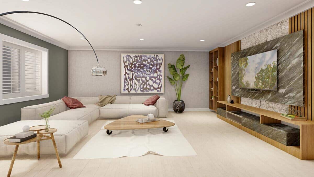 Family room with an L-shaped sectional, wooden tables, and a TV fixed against the marble accent panel.