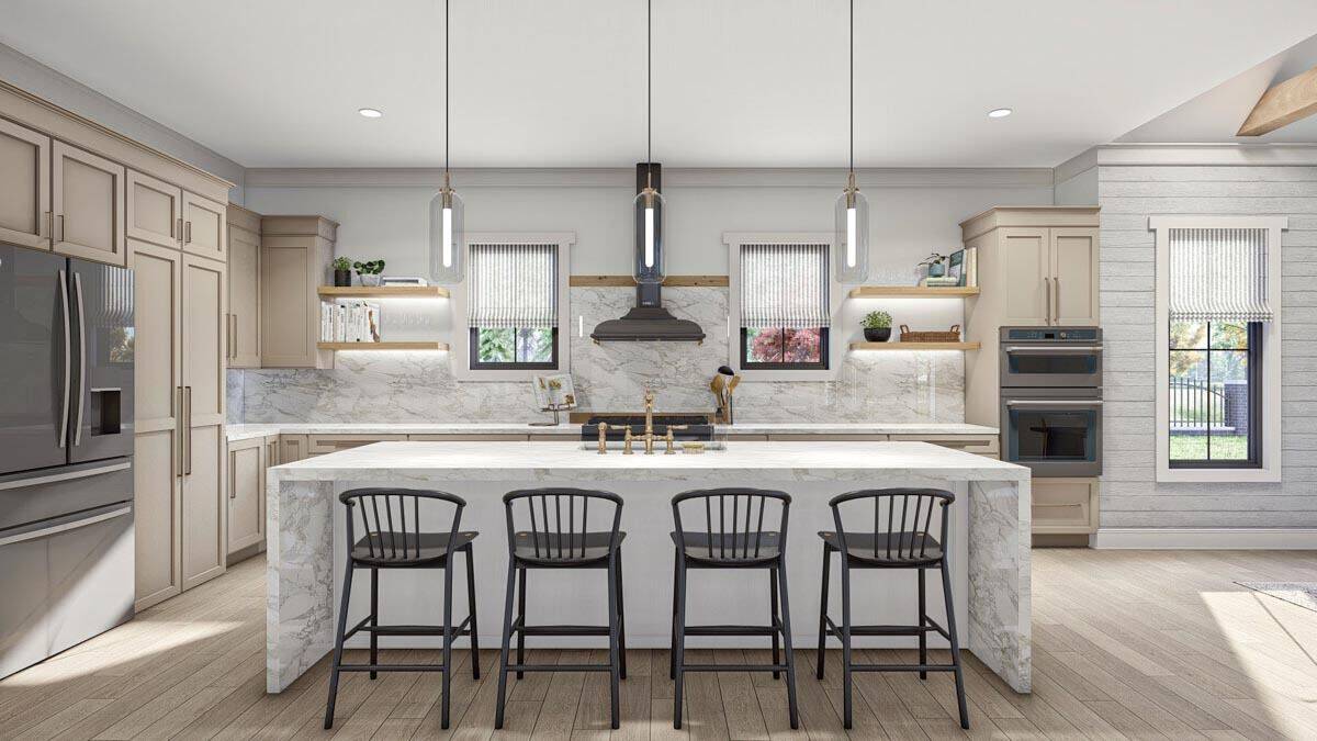 Kitchen with light wood cabinets, slate appliances, and a waterfall island lined with four counter stools.