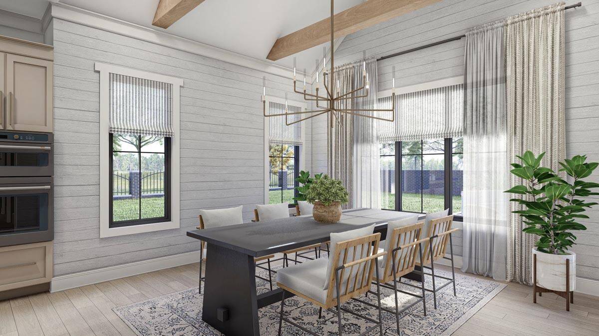 Dining room with a wooden dining set, a candle chandelier, and great views of the lush backyard.