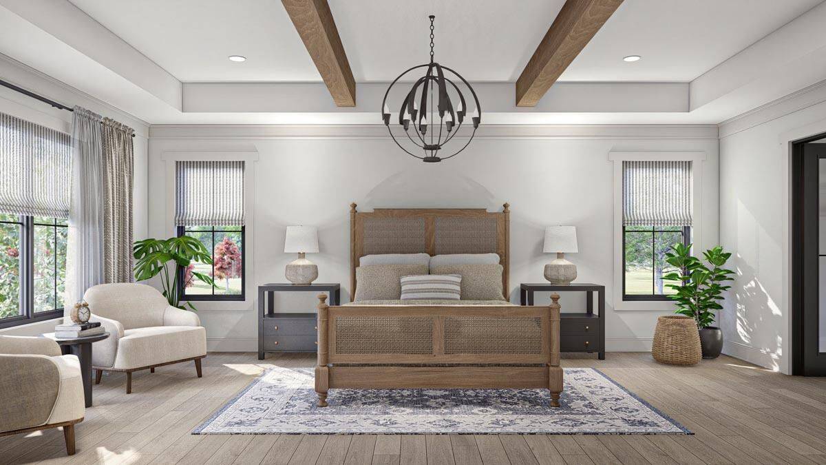 Primary bedroom with a rattan bed, round-back chairs, and a tray ceiling adorned with exposed beams and a spherical chandelier.