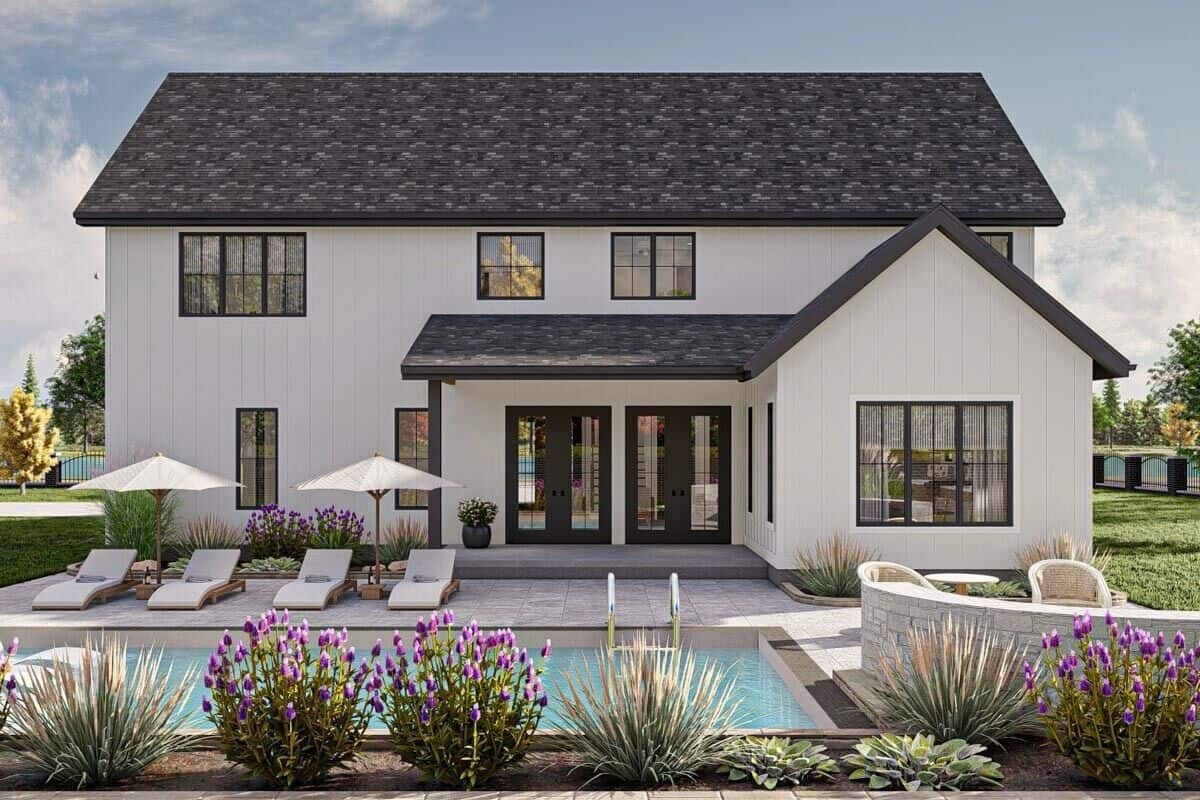 Rear view of the house with a covered porch and a pool terrace.