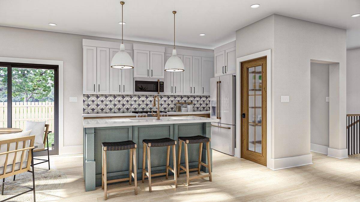 Kitchen with white cabinets, stainless steel appliances, a breakfast island, and a walk-in pantry with a glazed door.