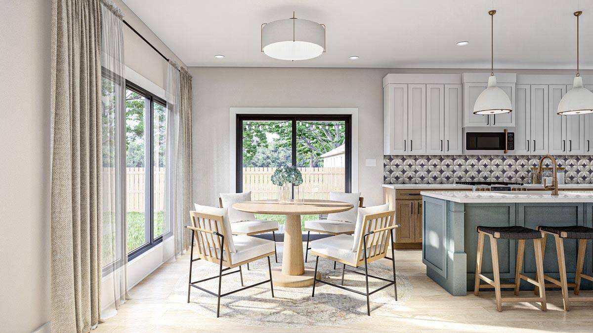 Dining area with a round dining set and sliding glass doors that open to the rear patio.