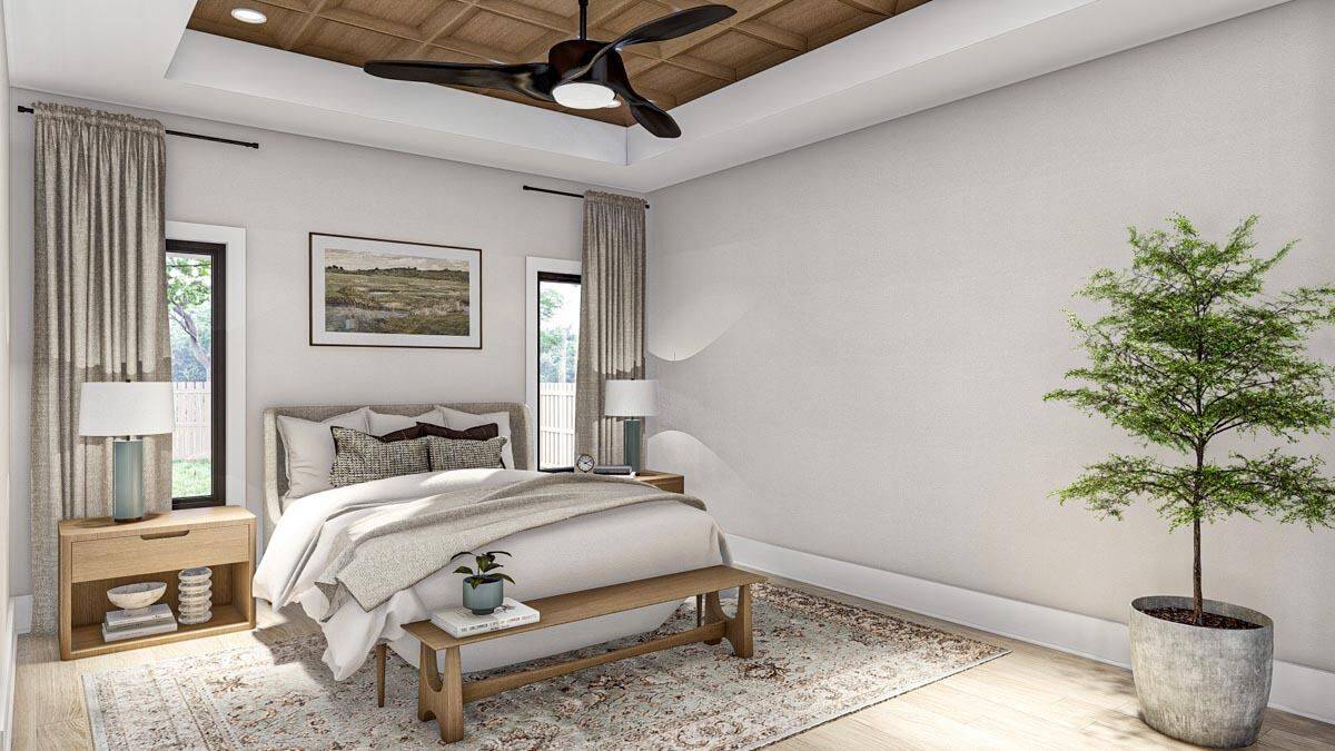 Primary bedroom with wooden furnishings, a tray ceiling, and a hardwood floor topped with a vintage area rug.