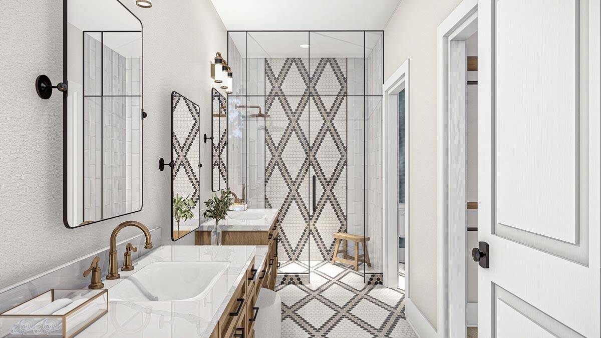 Primary bathroom with his and her vanities and a walk-in shower highlighted by decorative tiles that match the flooring.
