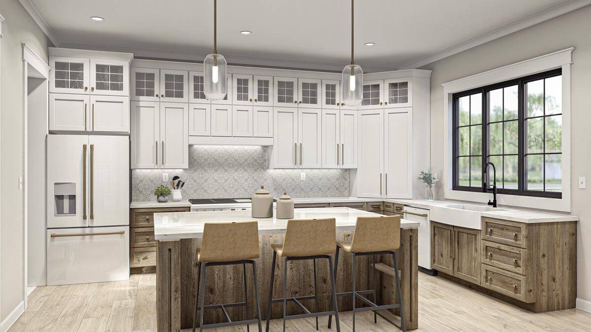 Kitchen with contrasting cabinetry, premium appliances, and a center island with seating for three.
