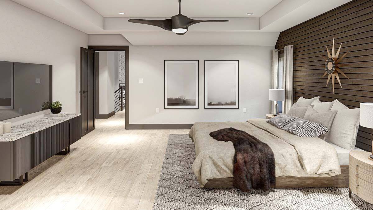 The primary bedroom includes a tray ceiling and a large TV mounted above the wooden console table.