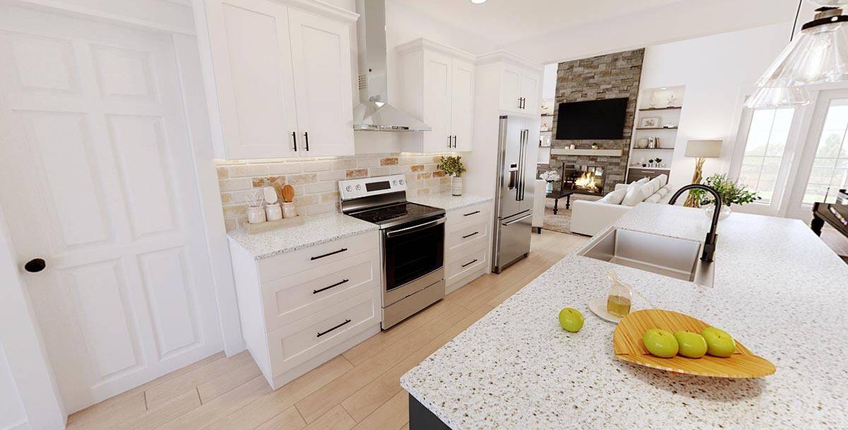 Kitchen with white cabinets, high-end appliances, and a breakfast island fitted with double sinks.