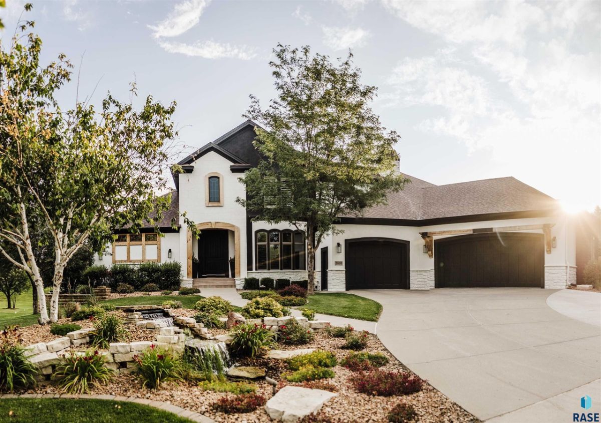 Front view of the house with a garage and spacious driveway.