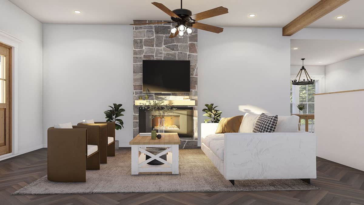 Great room with modern seats, a wooden coffee table, and a stone fireplace with a TV on top.