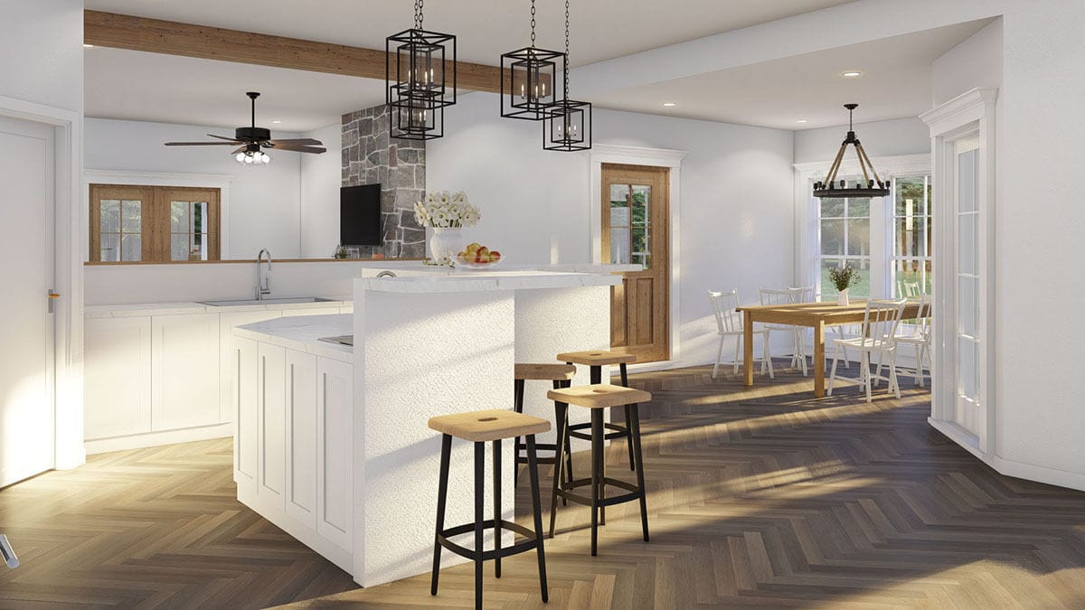 Kitchen and dining room with white walls and parquet flooring.