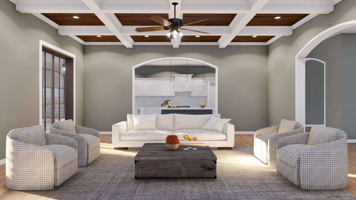 A coffered ceiling mounted with a fan crowns the great room.