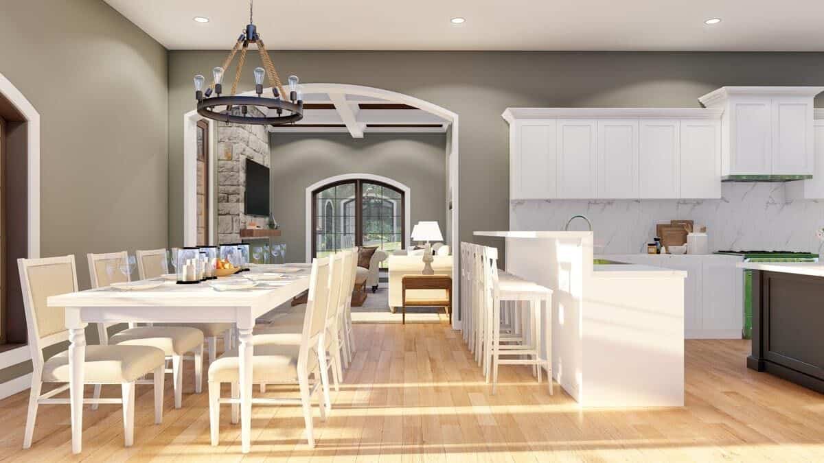 Breakfast nook and kitchen with with hardwood flooring and gray walls.