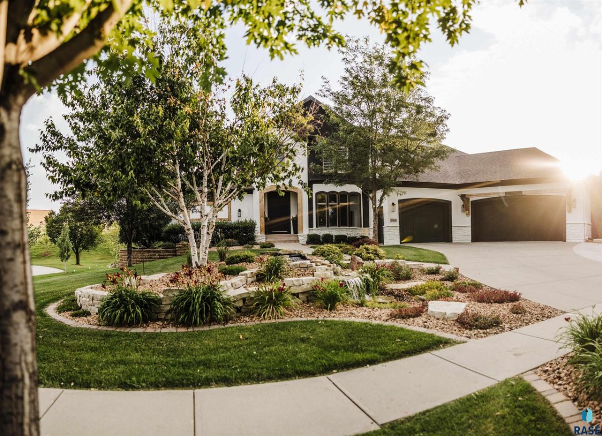 Front view of the house with a garage and spacious driveway.