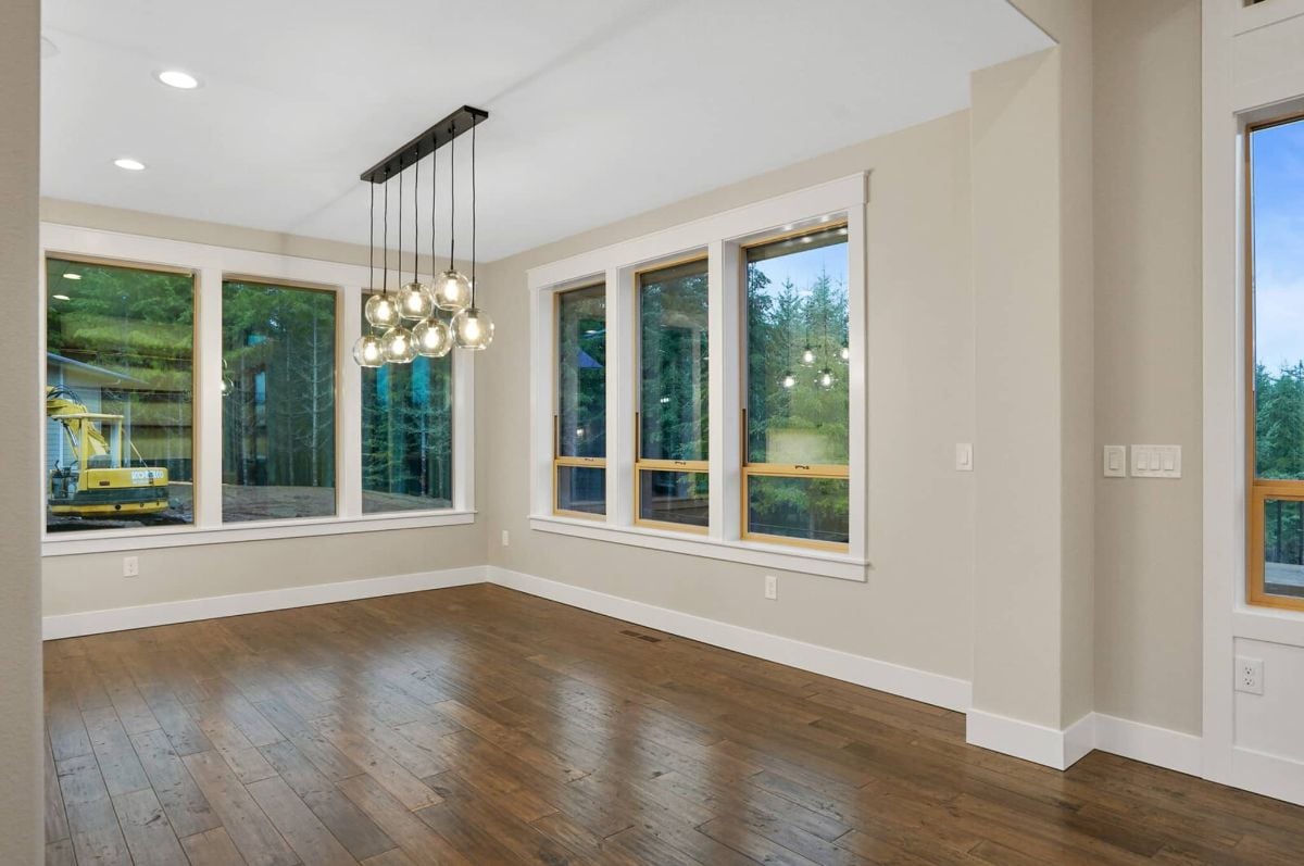 Dining room with wood floors and glass windows.