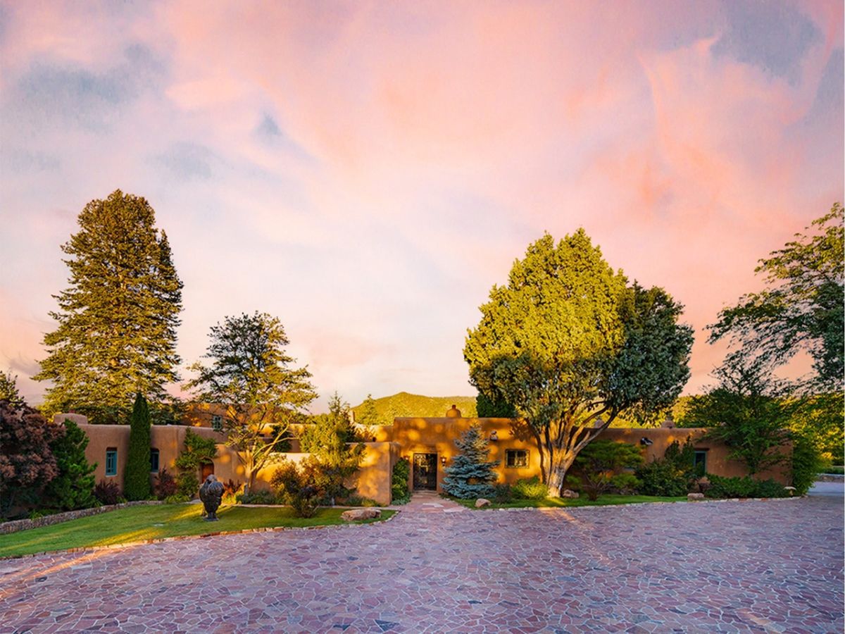 Surrounded by magnificent grounds, trees, and stone walls.