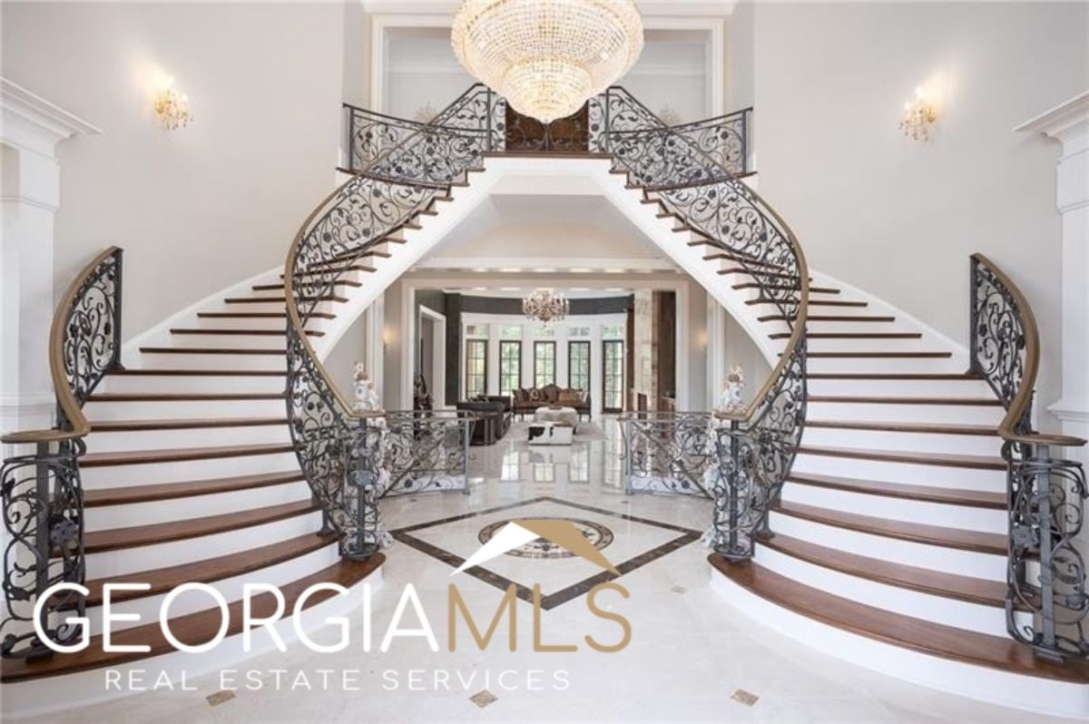 Grand Foyer with a chandelier and staircases.