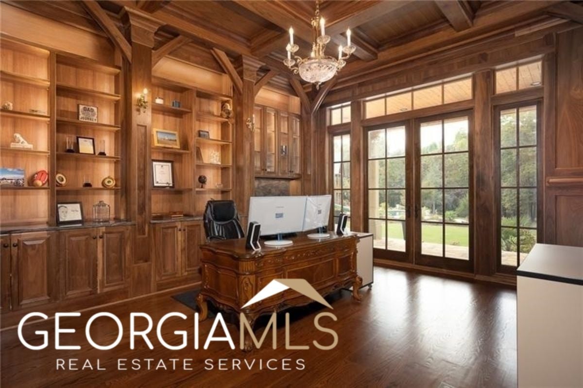 Home office with wood flooring.