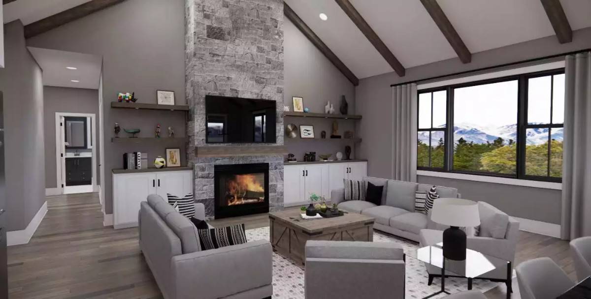 Great room with gray seats, a rustic coffee table, and a stone fireplace topped with a TV.